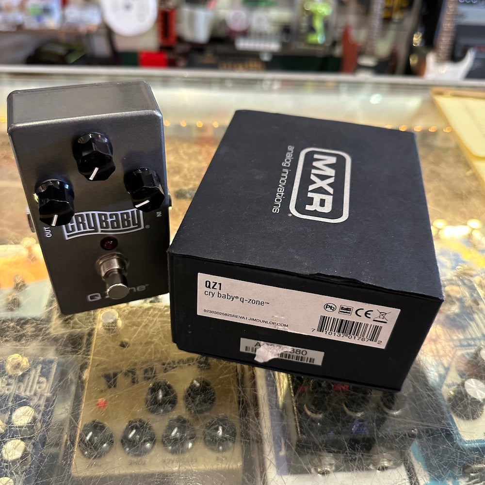 MXR guitar effects pedal and its packaging on a reflective surface