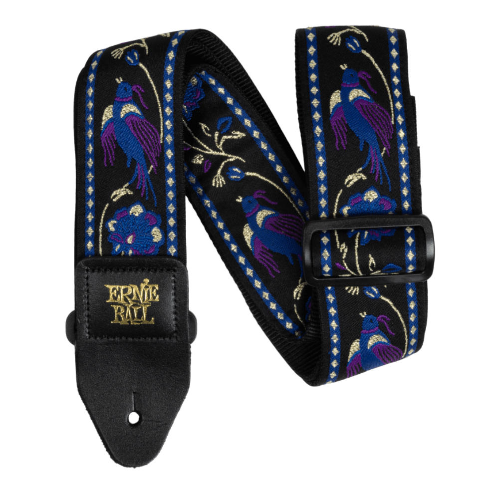 An Ernie Ball Classic Jacquard Guitar Strap featuring a purple background with a floral pattern and prominent pheasant imagery. The strap has premium leather ends and is designed to be adjustable in length.