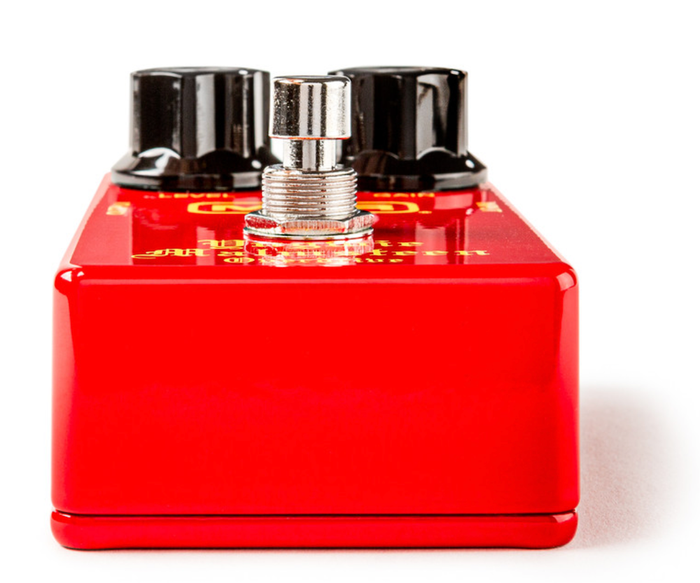 Red guitar effects pedal with black and silver knobs on a white background