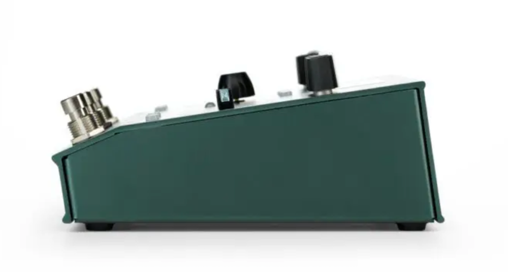 Green guitar effects pedal on a white background