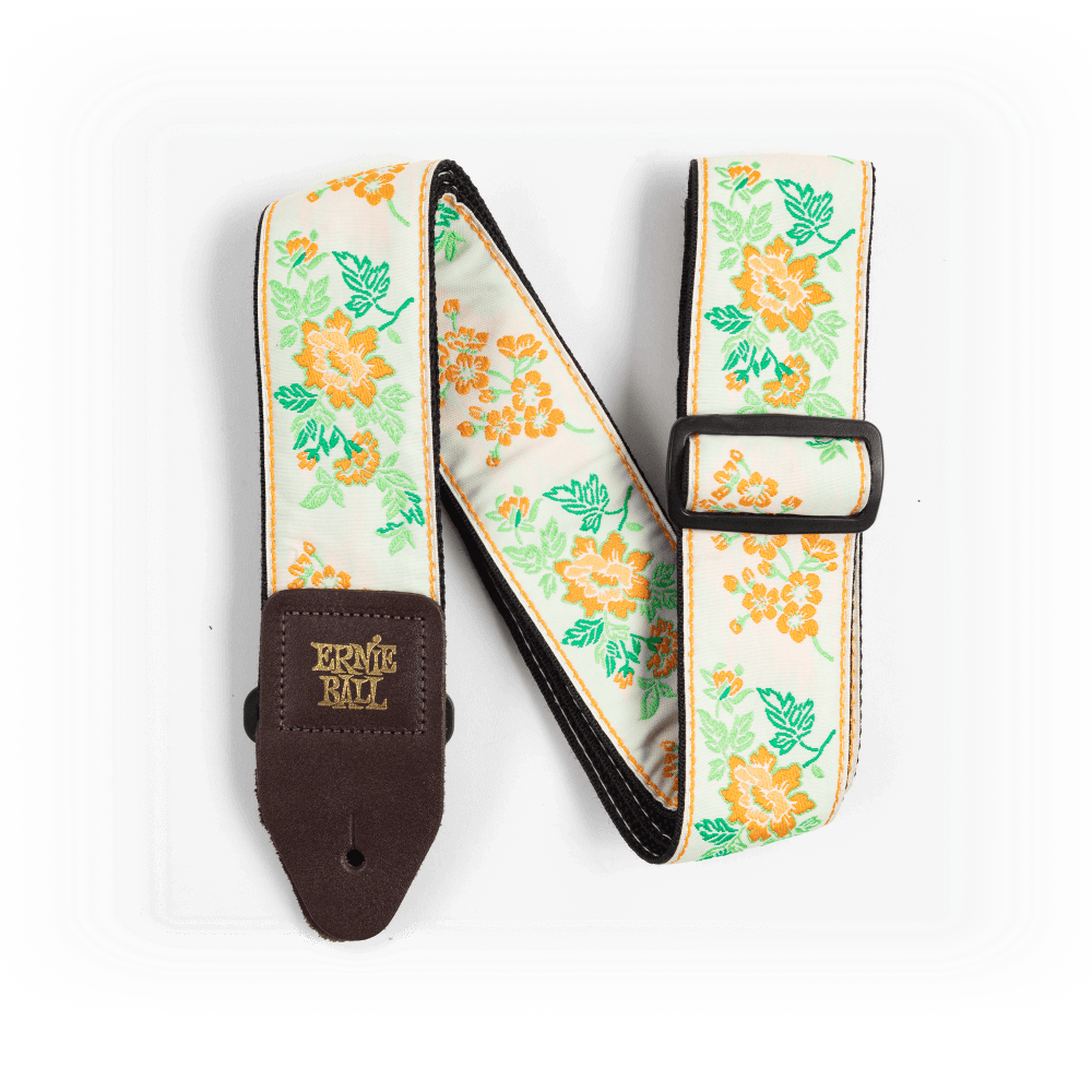 Floral-patterned guitar strap with brown end piece on a white background