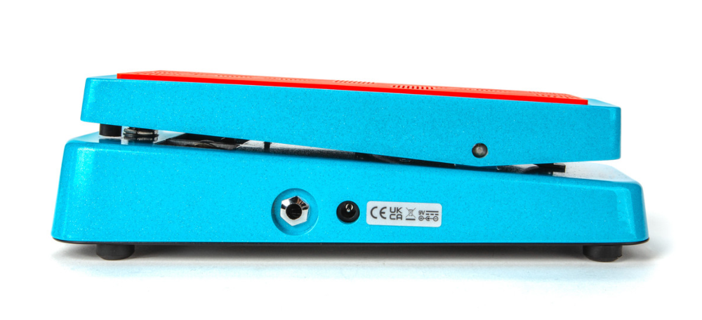 Blue guitar pedal with red top on a white background