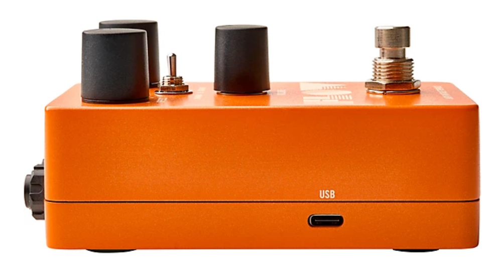 Orange electronic pedal with knobs and USB port on a white background